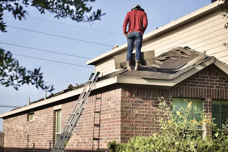 Professional roofer working on a residential roof in Spangler